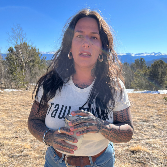 Jennifer holding a jar of Raw Milk out in the Colorado Wild.